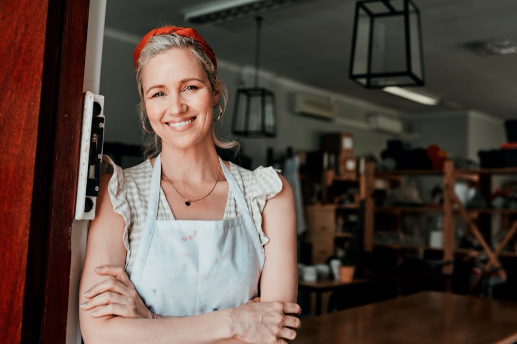 An environmental portrait: one person where they work, looking at the camera.