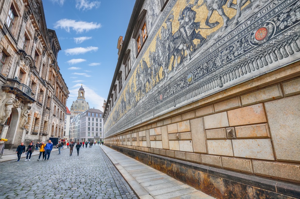 A steep Lisbon lane with tiled façades.