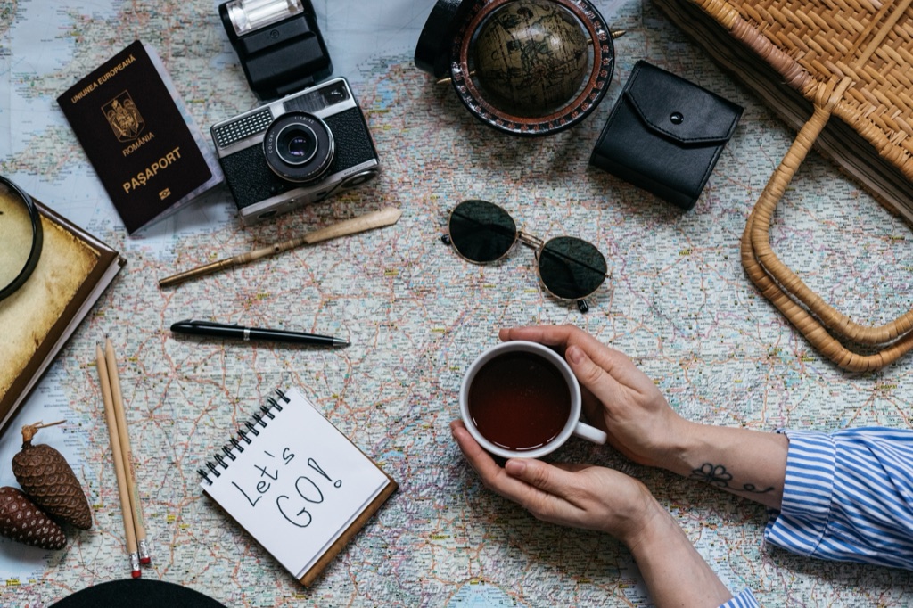 A notebook and a map on a table, mid-planning.
